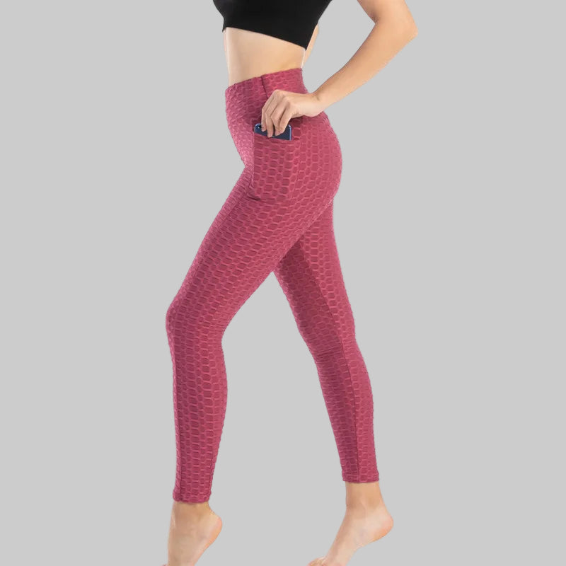 Maroon leggings worn by a person on a white background
