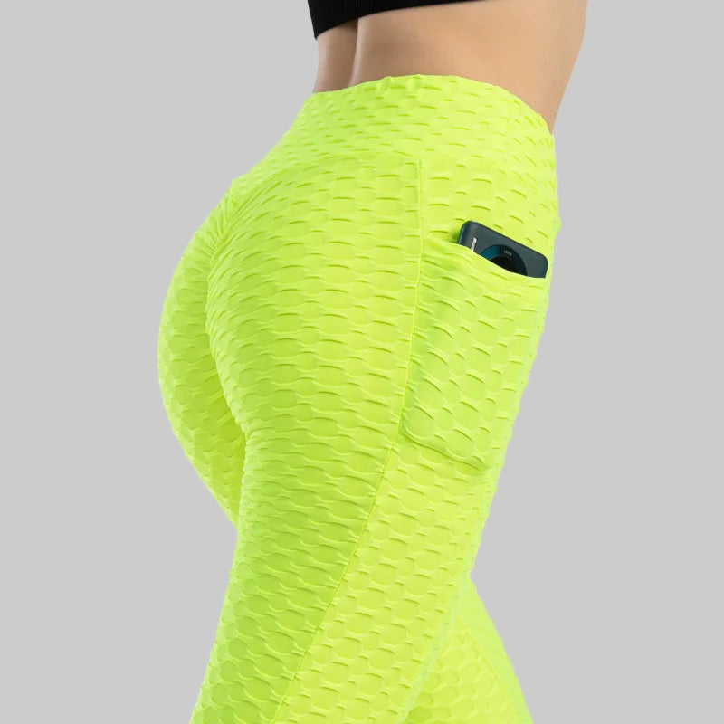 Neon green leggings with a pocket on a white background