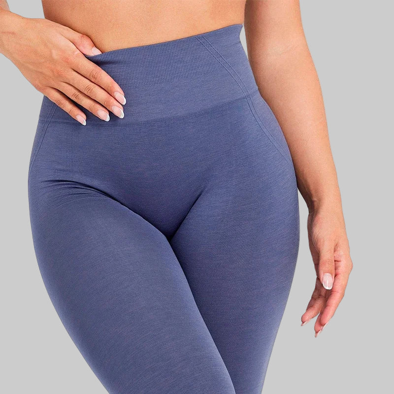 Blue leggings worn by a person on a white background