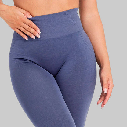 Blue leggings worn by a person on a white background