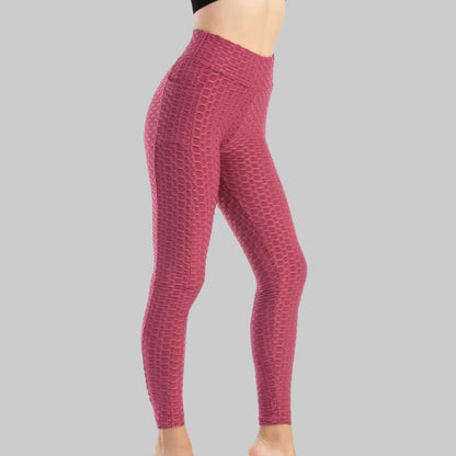 Red patterned leggings worn by a person on a white background