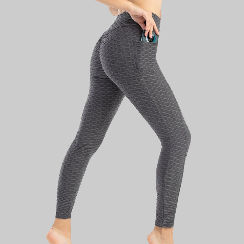 Gray patterned leggings worn by a person on a white background