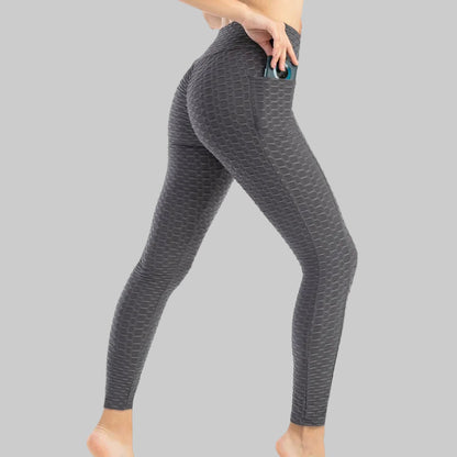 Gray patterned leggings worn by a person on a white background
