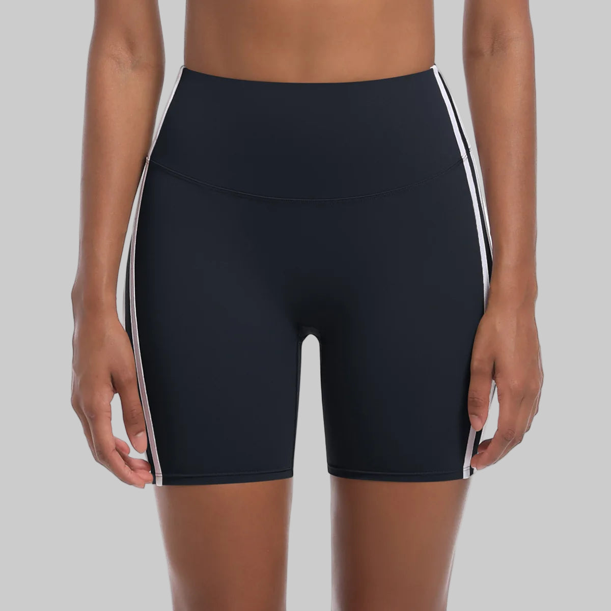 Black athletic shorts with white stripes on a white background