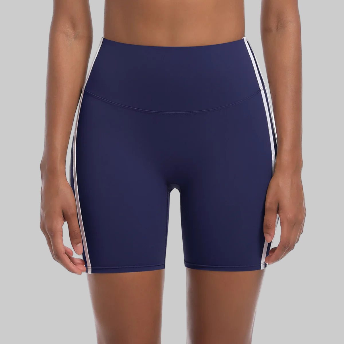 Navy blue athletic shorts with white stripes on a white background