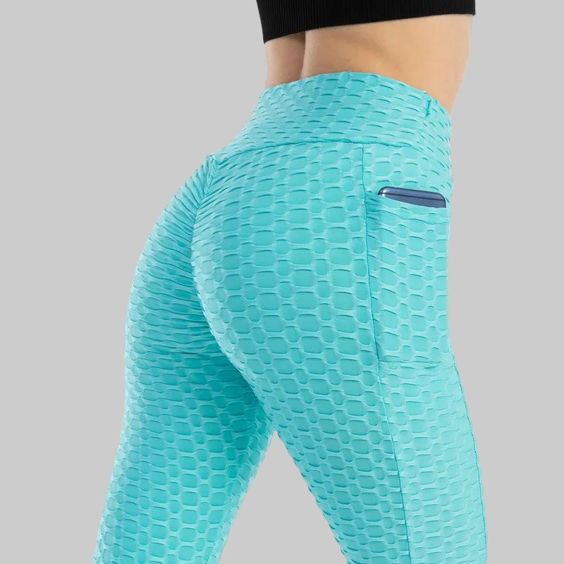 Teal leggings with a textured pattern on a white background