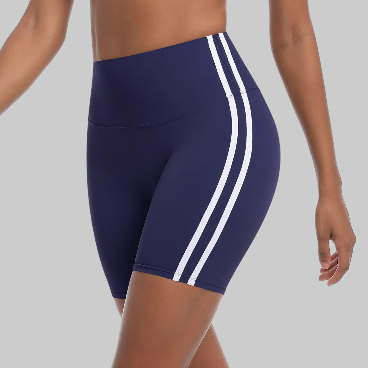 Navy blue athletic shorts with white stripes on a white background