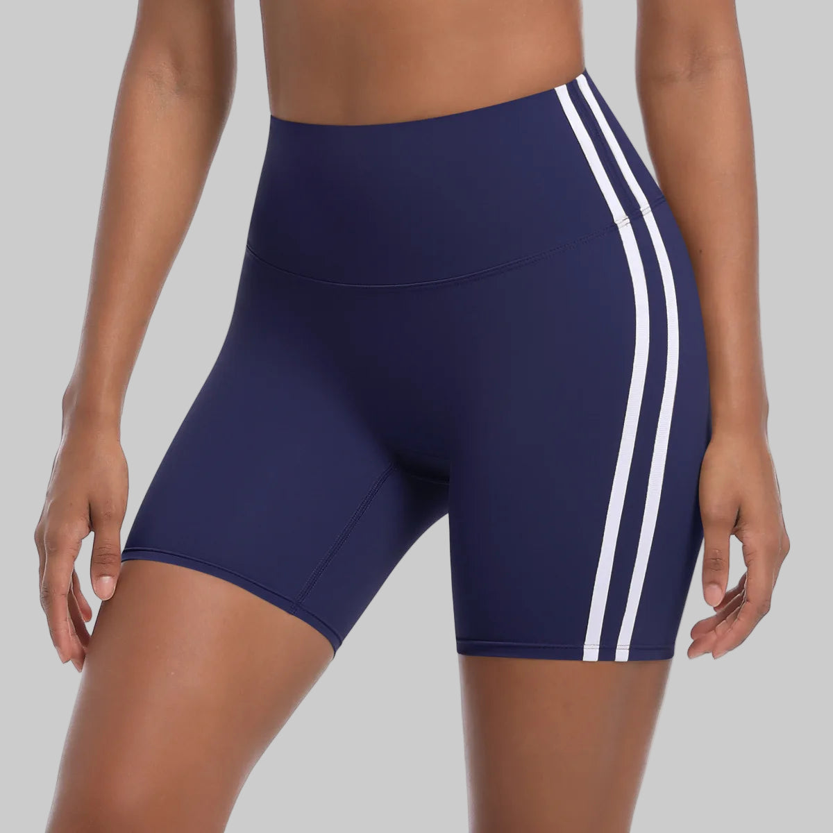 Navy blue athletic shorts with white stripes on a white background