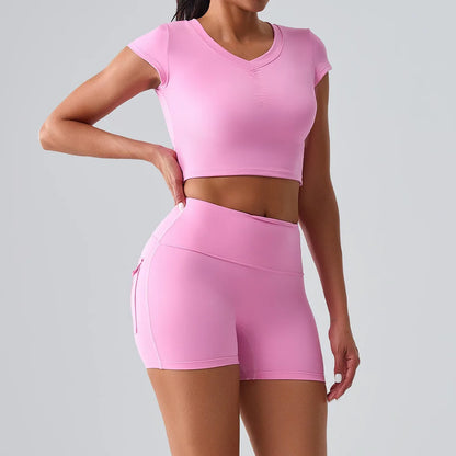Women's pink activewear set with pocketed t-shirt and shorts, perfect for Pilates, gym, and comfortable training