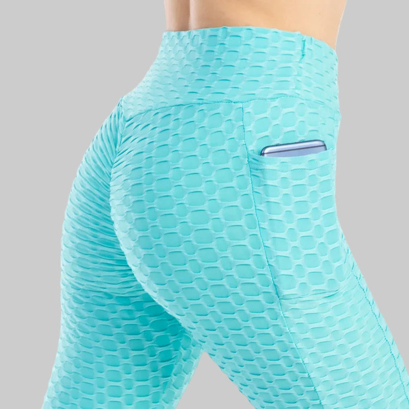 Teal patterned leggings with a pocket on a white background