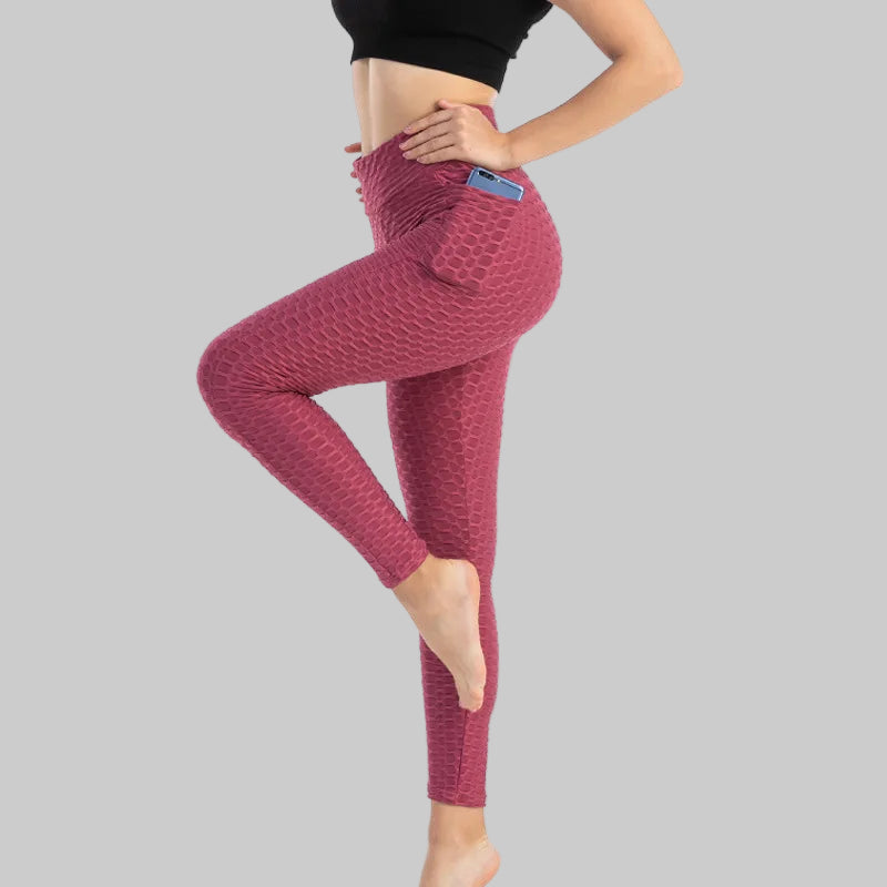Person wearing red textured leggings on a white background