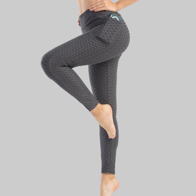 Person wearing gray leggings on a white background