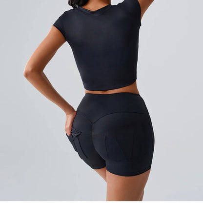 
Women's black activewear set with t-shirt and shorts featuring pockets, ideal for Pilates, gym, and comfortable workouts