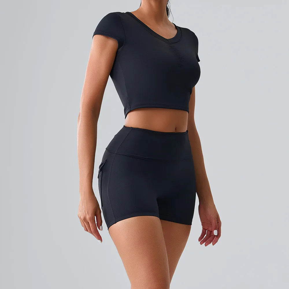 Women's black workout set with pocketed t-shirt and shorts, perfect for yoga, Pilates, gym, and all kinds of training sessions