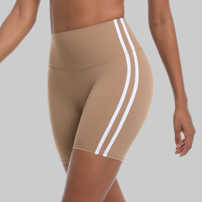 Beige athletic shorts with white stripes on a white background