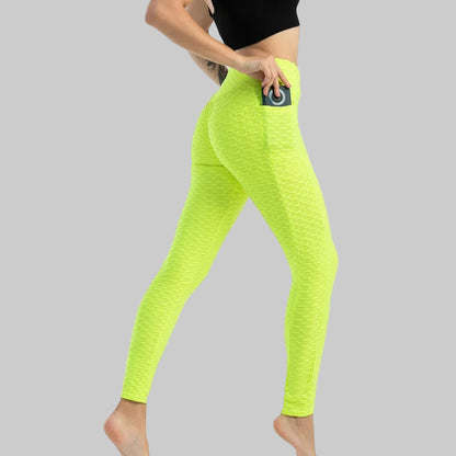 Neon green leggings worn by a person on a white background
