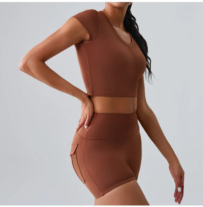 Women's brown activewear set with pocketed t-shirt and shorts, ideal for Pilates, gym, and comfortable training