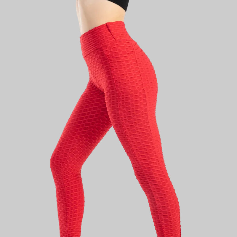 Red textured leggings worn by a person on a white background