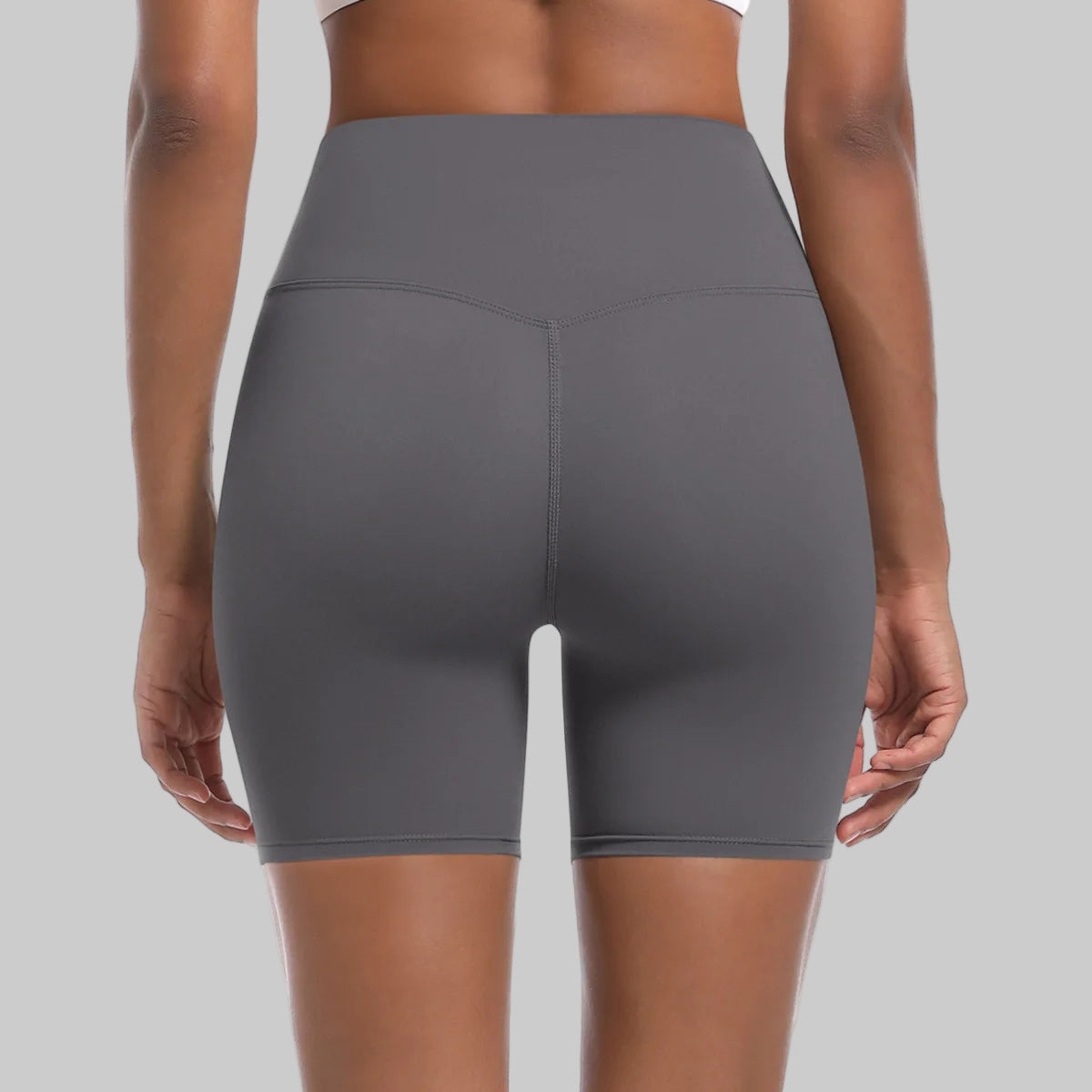 Gray athletic shorts worn by a person on a white background