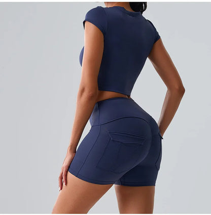 Women's blue activewear set with pocketed t-shirt and shorts, ideal for Pilates, gym, and comfortable training sessions