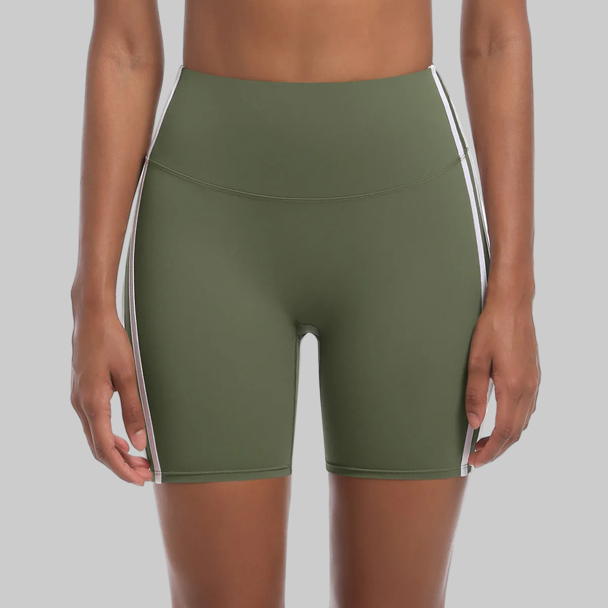 Green athletic shorts with white stripes on a white background
