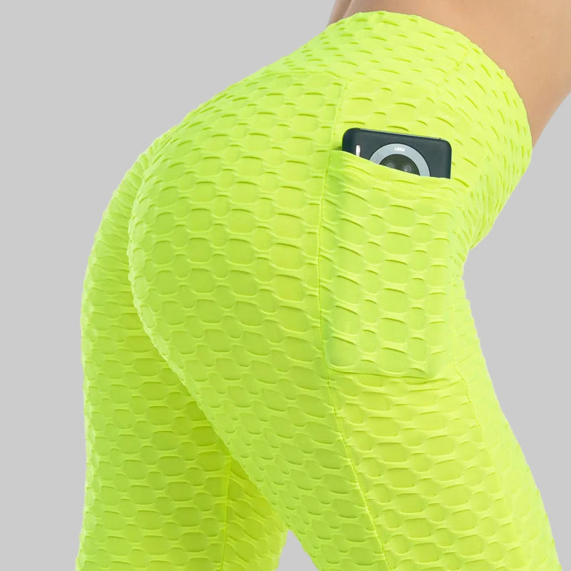 Neon green textured leggings with a pocket on a white background