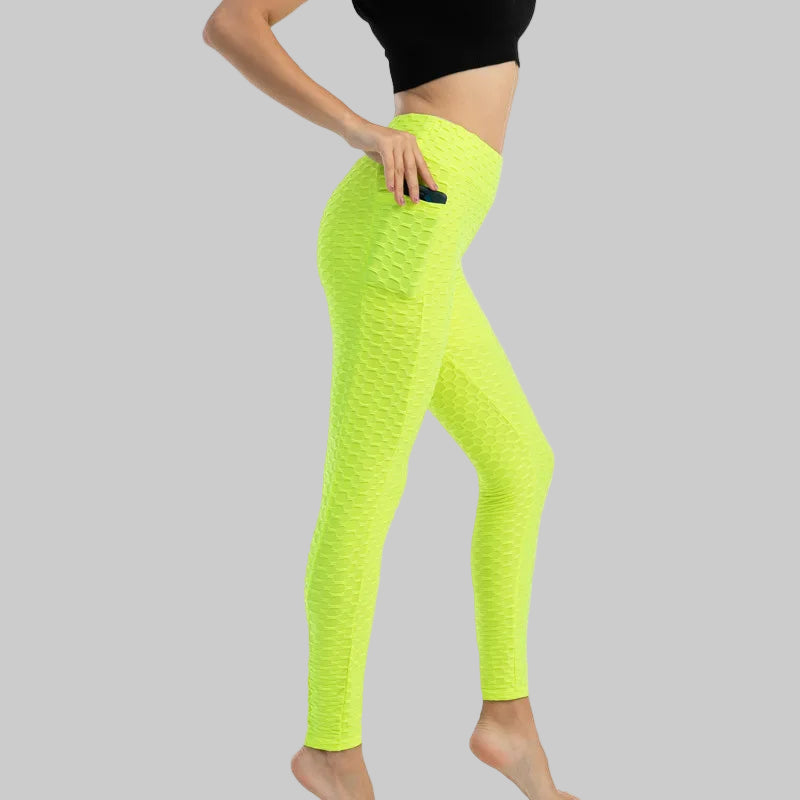 Neon green leggings worn by a person on a white background