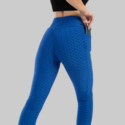 Blue textured leggings worn by a person on a white background