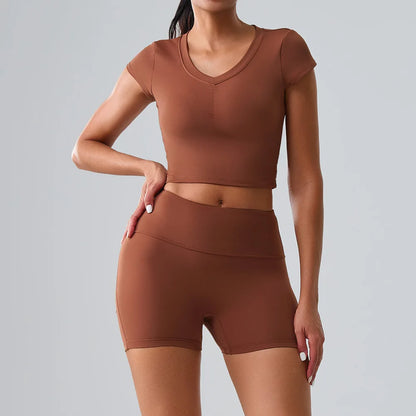 Women's brown activewear set featuring t-shirt and shorts with pockets, ideal for Pilates, gym, and training sessions
