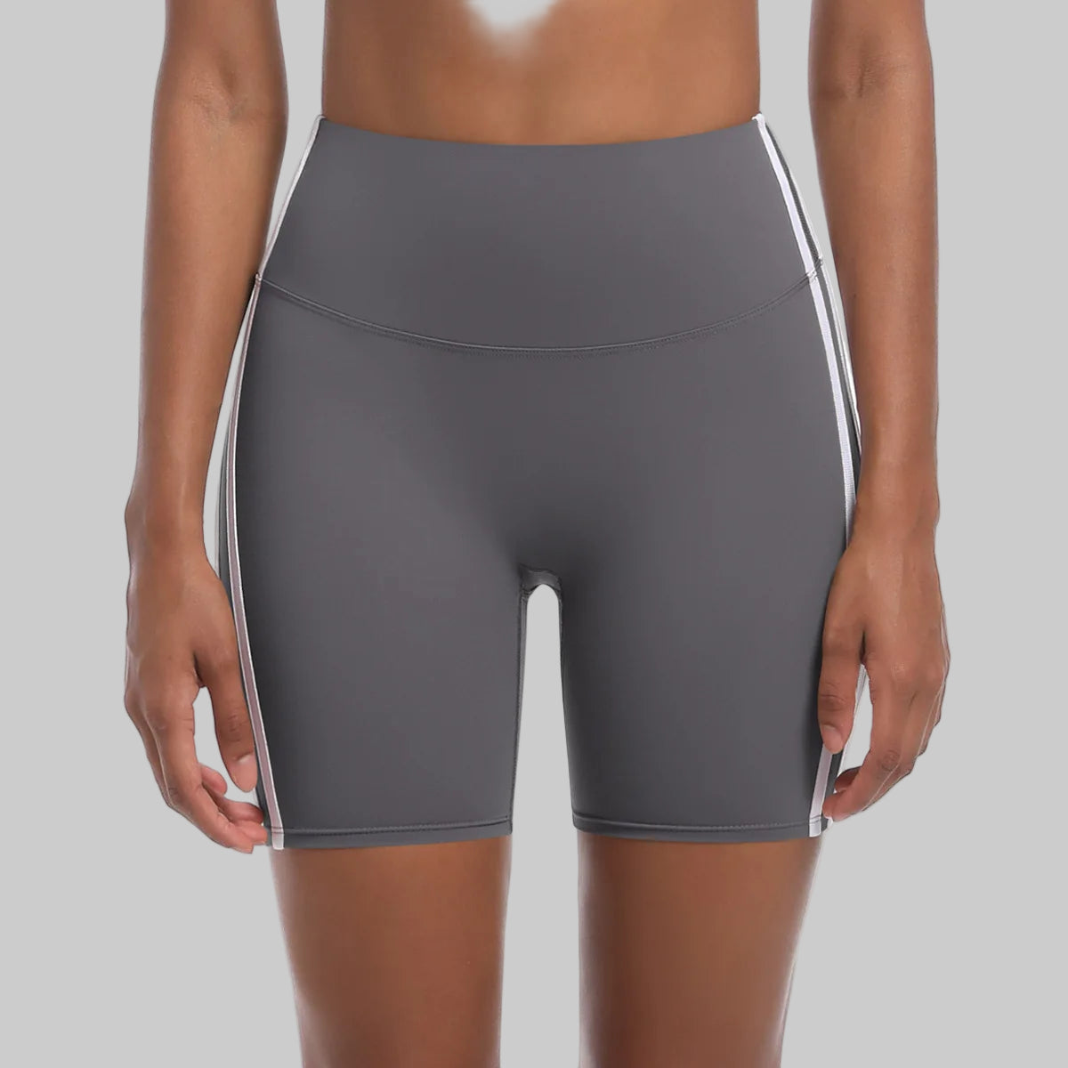 Gray athletic shorts with white stripes on a white background