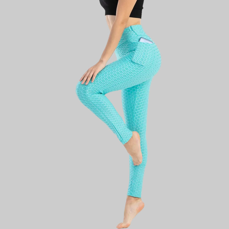 Turquoise leggings worn by a person on a white background