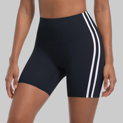Black athletic shorts with white stripes on a white background