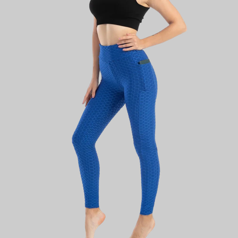 Person wearing blue leggings on a white background