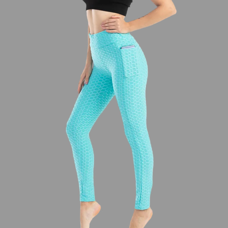 Turquoise leggings worn by a person on a white background