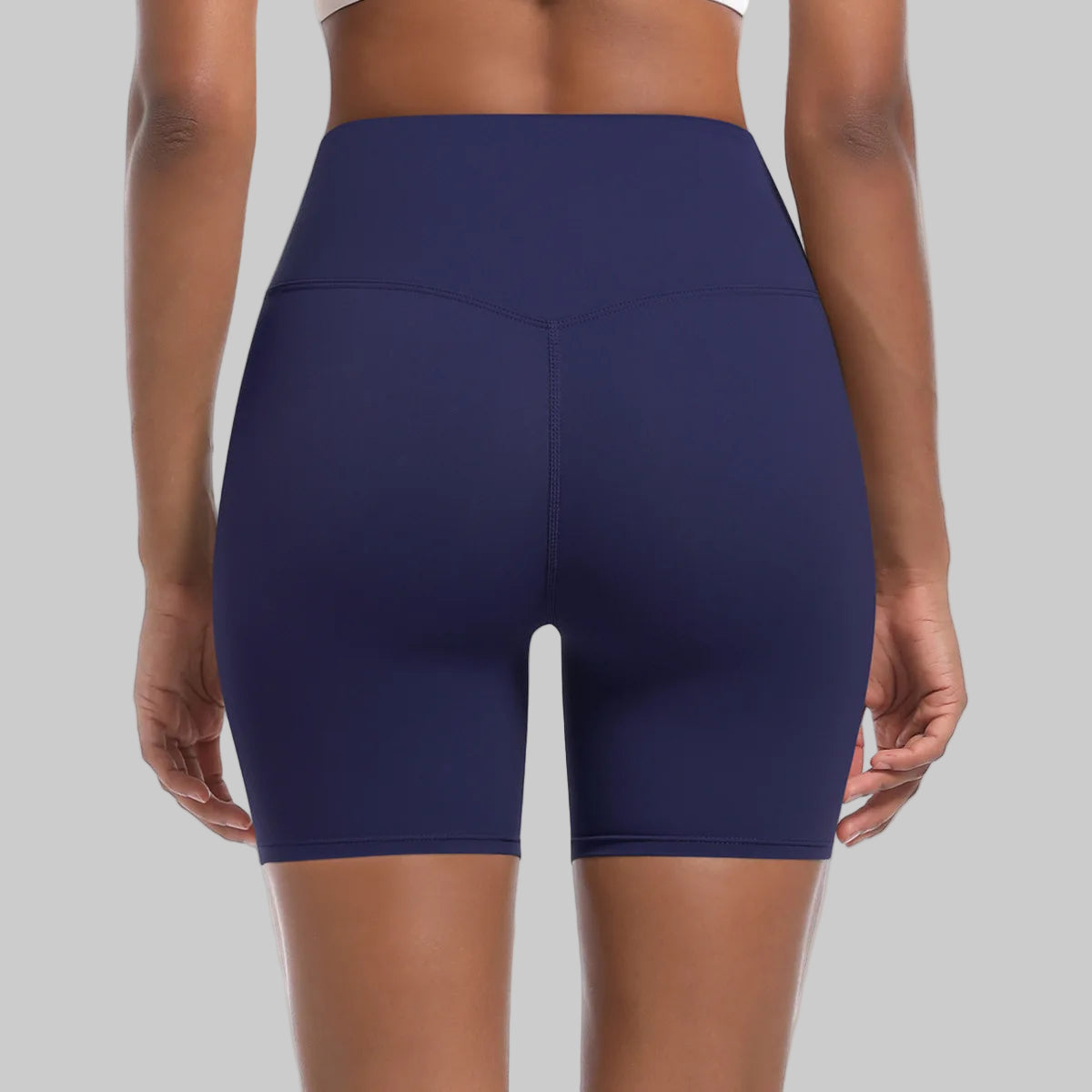 Navy blue athletic shorts worn by a person on a white background