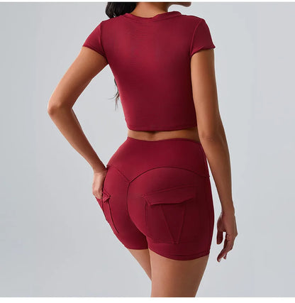 Women's red sporty set featuring t-shirt and shorts with pockets, ideal for Pilates, gym, and training sessions