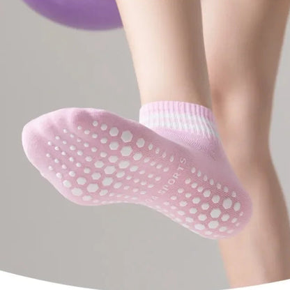 Pink slipper with textured sole on a blurred background