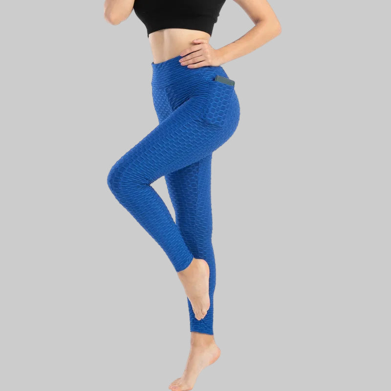 Person wearing blue leggings on a white background