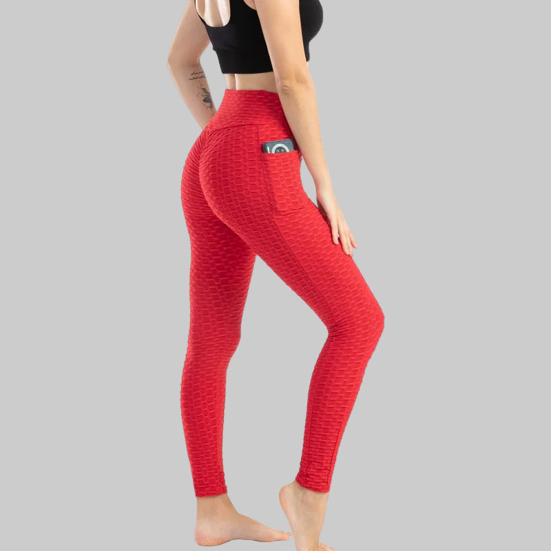Red leggings worn by a person on a white background