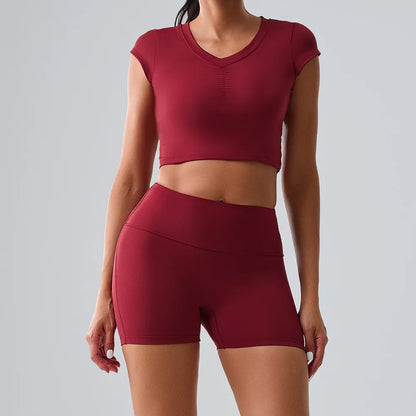 Women's red activewear set with pocketed t-shirt and shorts, perfect for yoga, running, and comfortable workouts