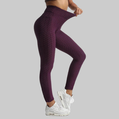 Person wearing purple leggings and white sneakers on a white background