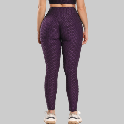 Purple patterned leggings worn by a person on a white background