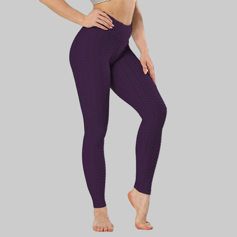 Purple leggings worn by a person on a white background