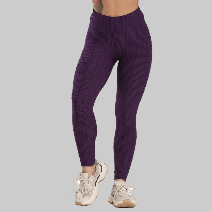 Purple leggings worn by a person on a white background