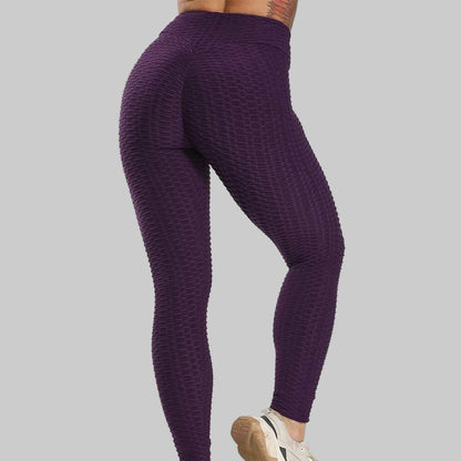 Purple textured leggings worn by a person on a white background